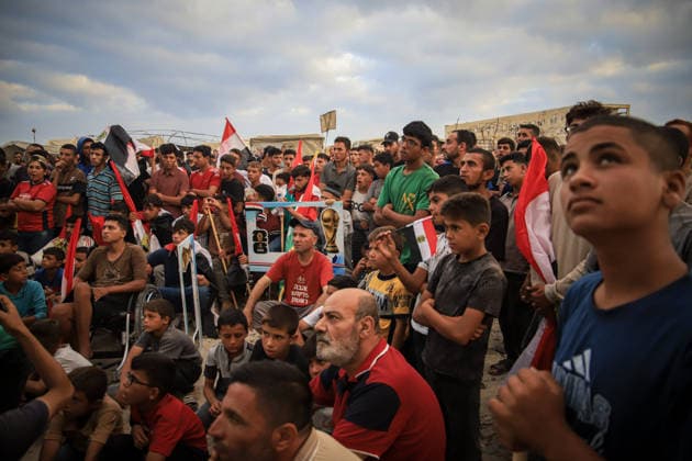 Palestinians watch the Iran-Egypt match on giant screens set up amid the rubble GAZA CITY, GAZA, PALESTINE - JUNE 27: Palestinians holding flags gather to watch the 2026 FIFA World Cup First Stage Group G match between Egypt and Iran on a giant screen set up among the rubble of destroyed buildings despite Israel s ongoing attacks in Gaza City, Gaza, Palestine, on June 27, 2026. Abdalhkem Abu Riash Anadolu Gaza City Gaza. Editorial use only. Please get in touch for any other usage.  Copyright: x2026xAnadoluxAbdalhkemxAbuxRiashx