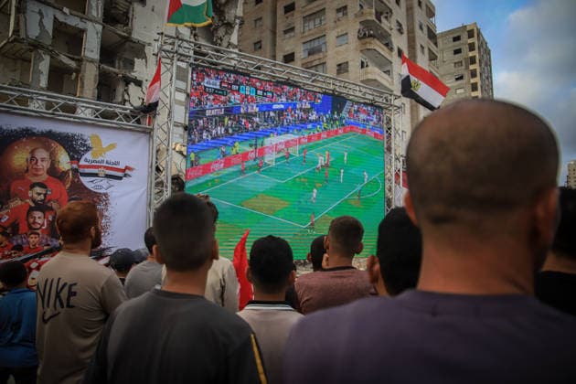 Palestinians watch the Iran-Egypt match on giant screens set up amid the rubble GAZA CITY, GAZA, PALESTINE - JUNE 27: Palestinians holding flags gather to watch the 2026 FIFA World Cup First Stage Group G match between Egypt and Iran on a giant screen set up among the rubble of destroyed buildings despite Israel s ongoing attacks in Gaza City, Gaza, Palestine, on June 27, 2026. Abdalhkem Abu Riash Anadolu Gaza City Gaza. Editorial use only. Please get in touch for any other usage.  Copyright: x2026xAnadoluxAbdalhkemxAbuxRiashx