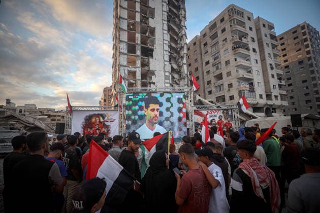 Palestinians watch the Iran-Egypt match on giant screens set up amid the rubble GAZA CITY, GAZA, PALESTINE - JUNE 27: Palestinians holding flags gather to watch the 2026 FIFA World Cup First Stage Group G match between Egypt and Iran on a giant screen set up among the rubble of destroyed buildings despite Israel s ongoing attacks in Gaza City, Gaza, Palestine, on June 27, 2026. Abdalhkem Abu Riash Anadolu Gaza City Gaza. Editorial use only. Please get in touch for any other usage.  Copyright: x2026xAnadoluxAbdalhkemxAbuxRiashx