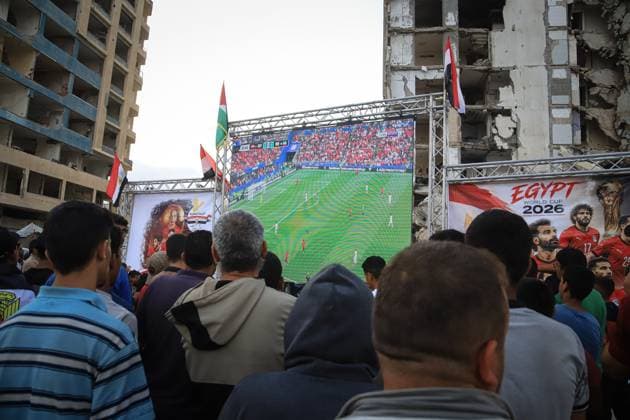 Displaced Gazans Watch Egypt-Iran World Cup Match Amid War Devastation GAZA, PALESTINE JUNE 27: Palestinians watch the FIFA World Cup 2026 match between Egypt and Iran among tents and the widespread destruction caused by the ongoing war in the Gaza Strip on the morning of June 27, 2026. Despite displacement and harsh humanitarian conditions, residents gather to follow the tournament as football offers a brief escape from daily hardships. Gaza Palestine, State of Copyright: x xMohammedxMxSkaikx xJNAxPressx