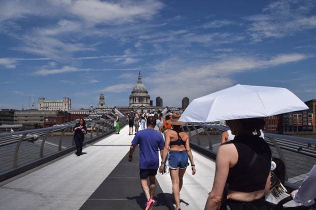 June 27, 2026, London, England, United Kingdom: A woman shelters under an umbrella from the scorching sun on Millennium Bridge as the heatwave continues in UK and Europe. London United Kingdom - ZUMAv130 20260627_zip_v130_006 Copyright: xVukxValcicx