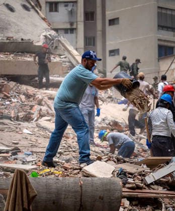 Volunteers and rescue workers gather on the rubble of collapsed buildings during rescue operations following the devastating earthquake across wide areas, in La Guaira, Venezuela, on June 26, 2026. photo by Government Ministry of Information (Venezuela)  VAN2026062625 GovernmentxMinistryxofxInformati