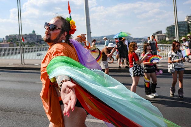 June 27, 2026, Budapest, Hungary, European Union: A young man wearing a rainbow floral crown, sunglasses and a rainbow cape runs through the crowd with his arms open on Elizabeth Bridge during Budapest Pride, with Buda Castle visible across the Danube. The march was the first held since HungaryÃ¢â‚¬â ¢s April 2026 parliamentary election. Budapest European Union - ZUMAo116 20260627_znp_o116_076 Copyright: xBiancaxOterox