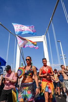 June 27, 2026, Budapest, Hungary, European Union: Women in bathing suits carry rainbow flags as a transgender pride flag flies above them while they march beneath the arches of Elizabeth Bridge during Budapest Pride. The march was the first held since HungaryÃ¢â‚¬â ¢s April 2026 parliamentary election. Budapest European Union  - ZUMAo116 20260627_znp_o116_077 Copyright: xBiancaxOterox