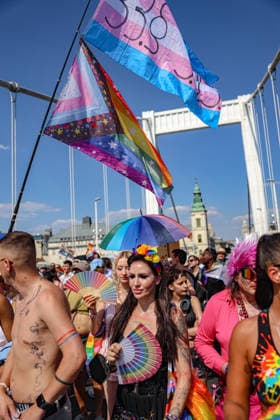 June 27, 2026, Budapest, Hungary, European Union: Marchers carrying hand fans walk beneath transgender and Progress Pride flags framed by the arches of Elizabeth Bridge during Budapest Pride. The march was the first held since HungaryÃ¢â‚¬â ¢s April 2026 parliamentary election. Budapest European Union - ZUMAo116 20260627_znp_o116_079 Copyright: xBiancaxOterox