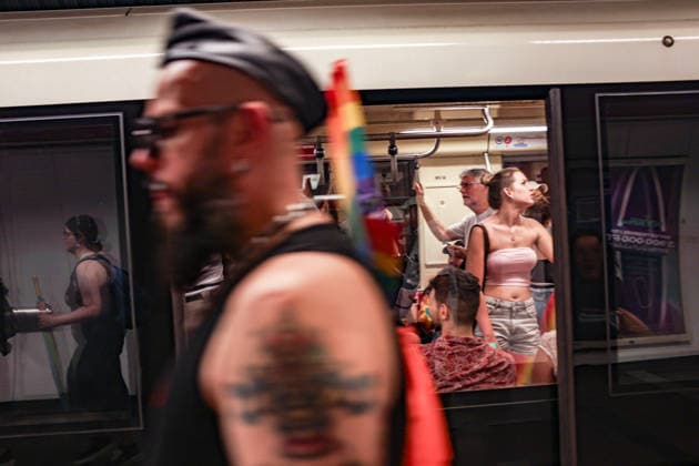 June 27, 2026, Budapest, Hungary, European Union: A man carrying a rainbow Pride flag walks past a metro train filled with passengers after the Budapest Pride parade. Budapest European Union  - ZUMAo116 20260627_znp_o116_099 Copyright: xBiancaxOterox