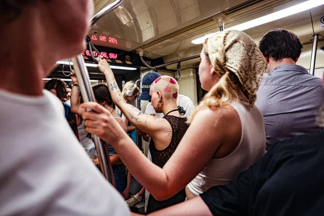 June 27, 2026, Budapest, Hungary, European Union: A woman with a shaved head decorated with painted hearts is surrounded by passengers inside a packed metro train after the Budapest Pride parade. Budapest European Union - ZUMAo116 20260627_znp_o116_101 Copyright: xBiancaxOterox