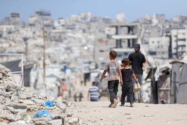Jabalia Gaza Daily Life Palestinian children walk past rubble and destroyed buildings in Jabalia, northern Gaza Strip on June 27, 2026. Residents remain among the ruins of damaged and destroyed buildings in Jabalia, where access to basic services such as water, electricity, and shelter remains severely limited. Gaza Gaza Strip Palestinian Territories Copyright: xAhmedxAlxArinix
