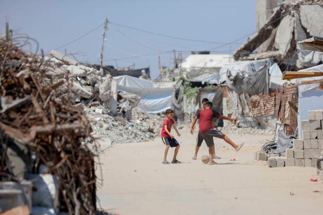 Jabalia Gaza Daily Life Palestinian children play football near makeshift shelters and rubble in Jabalia, northern Gaza Strip on June 27, 2026. Residents remain among the ruins of damaged and destroyed buildings in Jabalia, where access to basic services such as water, electricity, and shelter remains severely limited. Gaza Gaza Strip Palestinian Territories Copyright: xAhmedxAlxArinix