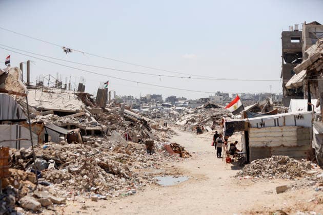 Jabalia Gaza Daily Life Palestinian residents walk along a road lined with rubble and damaged buildings in Jabalia, northern Gaza Strip on June 27, 2026. Residents remain among the ruins of damaged and destroyed buildings in Jabalia, where access to basic services such as water, electricity, and shelter remains severely limited. Gaza Gaza Strip Palestinian Territories Copyright: xAhmedxAlxArinix