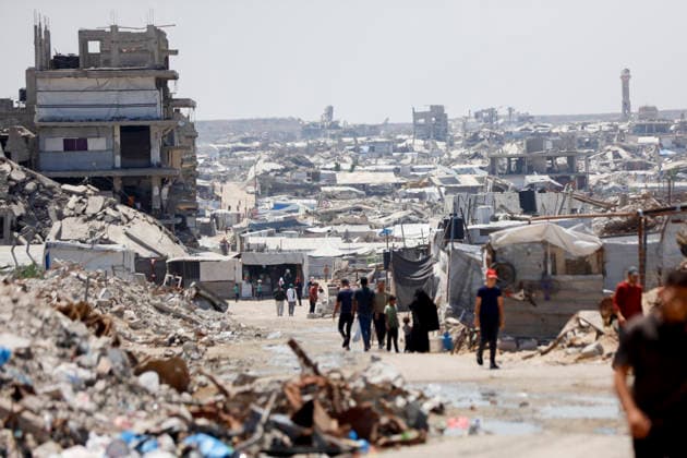 Jabalia Gaza Daily Life Palestinian residents walk along a road lined with makeshift shelters and rubble in Jabalia, northern Gaza Strip on June 27, 2026. Residents remain among the ruins of damaged and destroyed buildings in Jabalia, where access to basic services such as water, electricity, and shelter remains severely limited. Gaza Gaza Strip Palestinian Territories Copyright: xAhmedxAlxArinix
