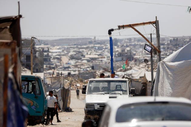 Jabalia Gaza Daily Life Vehicles move along a road between makeshift shelters and damaged buildings in Jabalia, northern Gaza Strip on June 27, 2026. Residents remain among the ruins of damaged and destroyed buildings in Jabalia, where access to basic services such as water, electricity, and shelter remains severely limited. Gaza Gaza Strip Palestinian Territories Copyright: xAhmedxAlxArinix