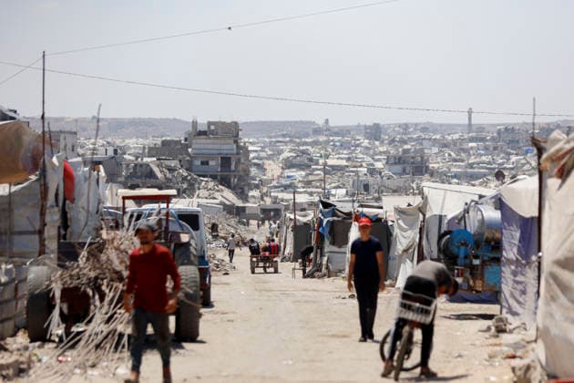 Jabalia Gaza Daily Life Palestinian residents walk along a road lined with makeshift shelters and rubble in Jabalia, northern Gaza Strip on June 27, 2026. Residents remain among the ruins of damaged and destroyed buildings in Jabalia, where access to basic services such as water, electricity, and shelter remains severely limited. Gaza Gaza Strip Palestinian Territories Copyright: xAhmedxAlxArinix