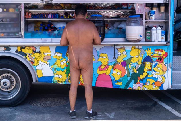 June 27, 2026, Los Angeles, California, USA: A participant in the World Naked Bike Ride buys food from a food truck before the annual ride through downtown Los Angeles on Saturday, June 27, 2026. Los Angeles USA - ZUMAc68_ 20260627_zaf_c68_013 Copyright: xRingoxChiux