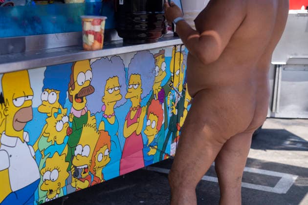 June 27, 2026, Los Angeles, California, USA: A participant in the World Naked Bike Ride buys food from a food truck before the annual ride through downtown Los Angeles on Saturday, June 27, 2026. Los Angeles USA - ZUMAc68_ 20260627_zaf_c68_014 Copyright: xRingoxChiux