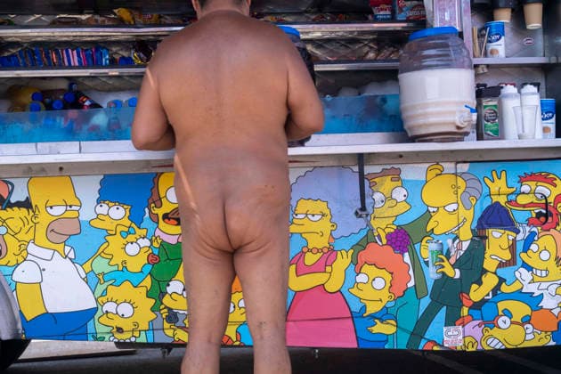 June 27, 2026, Los Angeles, California, USA: A participant in the World Naked Bike Ride buys food from a food truck before the annual ride through downtown Los Angeles on Saturday, June 27, 2026. Los Angeles USA - ZUMAc68_ 20260627_zaf_c68_020 Copyright: xRingoxChiux
