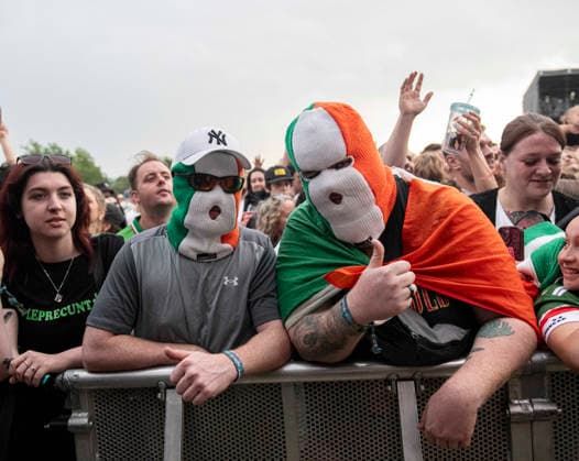 Kneecap performing live at Crystal Palace Park, London 27 June 2026 Kneecap performing live at Crystal Palace Park, London 27 June 2026 Fans in the crowd Kneecap are an Irish hip-hop trio. They rap in a mixture of English and Irish. Their first single C.E.A.R.T.A. (cearta is Irish for rights ) was released in ˜17, followed by their mixtape, 3CAG, in ˜18. Their first studio album, Fine Art, was released in ˜24 Their second studio album, Fenian, was released in ˜26. The group has been at the centre of public debates about free speech and the expression of political opinions within Ireland and the UK. Their themes focus on working class, youth culture, Irish republicanism and Irish language rights. In concert, they have made stateme  Copyright: xDafyddxOwenx xDafyddxOwenx-xB5377x xAvalonx 1112996542