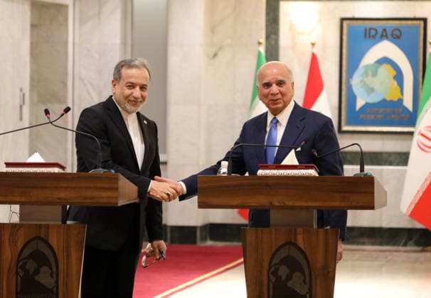 (260628) -- BAGHDAD, June 28, 2026 -- Iraqi Foreign Minister Fuad Hussein (R) and his visiting Iranian counterpart Seyed Abbas Araghchi shake hands during a joint press conference in Baghdad, Iraq, on June 28, 2026. Hussein met Araghchi here on Sunday to discuss bilateral ties and regional security. ) IRAQ-BAGHDAD-IRAN-FM-VISIT KhalilxDawood 