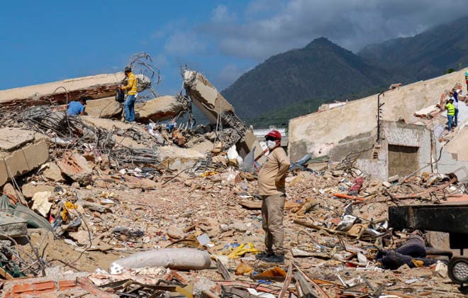 Members of Caracas firefighters search for victims amid debris of a demolished building after a magnitude 7.2 earthquake struck Venezuela and other regions in the Caribbean in La Guaira, Venezuela, on June 27, 2026. According to the U.S. Geological Survey, a powerful 7.5?magnitude aftershock struck after the main quake. Medical and media sources reported that the death toll has risen to around 1,500, with some 3,000 others injured. A web page created to track the missing has listed nearly 50,000 people as unaccounted for. photo by Jonathan Lanza  VAN2026062811 JonathanxLanza