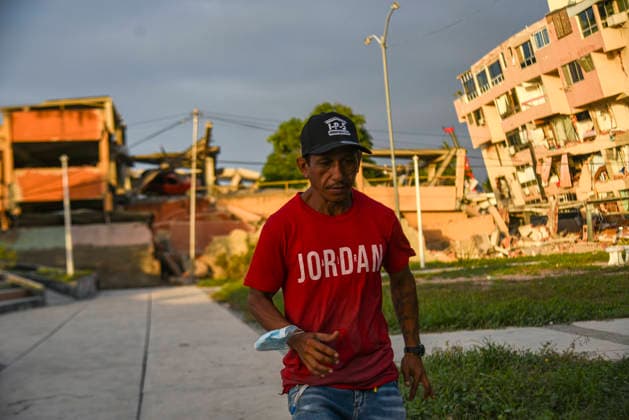A Venezuelan man walks beside destroyed buildings, as rescue teams continue searching for victims amid debris of a demolished building after a magnitude 7.2 earthquake struck Venezuela and other regions in the Caribbean in La Guaira, Venezuela, on June 27, 2026. According to the U.S. Geological Survey, a powerful 7.5?magnitude aftershock struck after the main quake. Medical and media sources reported that the death toll has risen to around 1,500, with some 3,000 others injured. A web page created to track the missing has listed nearly 50,000 people as unaccounted for.  VAN2026062813 JonathanxLanza