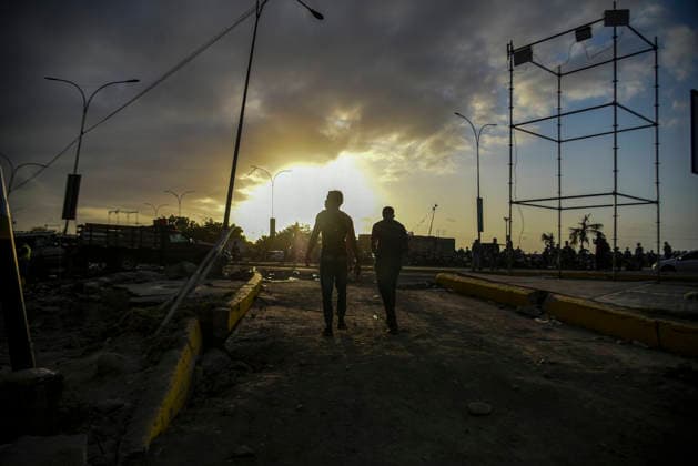 Venezuelan men walks beside destroyed buildings, as rescue teams continue searching for victims amid debris of a demolished building after a magnitude 7.2 earthquake struck Venezuela and other regions in the Caribbean in La Guaira, Venezuela, on June 27, 2026. According to the U.S. Geological Survey, a powerful 7.5?magnitude aftershock struck after the main quake. Medical and media sources reported that the death toll has risen to around 1,500, with some 3,000 others injured. A web page created to track the missing has listed nearly 50,000 people as unaccounted for.  VAN2026062814 JonathanxLanza