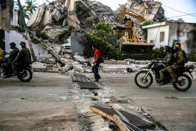 Venezuelan army soldiers ride motorcycles as rescue teams continue searching for victims amid debris of a demolished building after a magnitude 7.2 earthquake struck Venezuela and other regions in the Caribbean in La Guaira, Venezuela, on June 27, 2026. According to the U.S. Geological Survey, a powerful 7.5?magnitude aftershock struck after the main quake. Medical and media sources reported that the death toll has risen to around 1,500, with some 3,000 others injured. A web page created to track the missing has listed nearly 50,000 people as unaccounted for.  VAN2026062818 JonathanxLanza