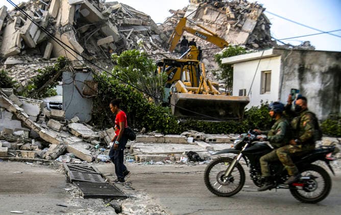 Venezuelan army soldiers ride motorcycles as rescue teams continue searching for victims amid debris of a demolished building after a magnitude 7.2 earthquake struck Venezuela and other regions in the Caribbean in La Guaira, Venezuela, on June 27, 2026. According to the U.S. Geological Survey, a powerful 7.5?magnitude aftershock struck after the main quake. Medical and media sources reported that the death toll has risen to around 1,500, with some 3,000 others injured. A web page created to track the missing has listed nearly 50,000 people as unaccounted for.  VAN2026062819 JonathanxLanza