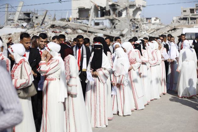 150 Palestinian couples tie the knot in mass wedding at Jabalia Camp GAZA, PALESTINE - JUNE 28: Newlyweds celebrate as 150 Palestinian couples tie the knot in a mass wedding ceremony organized by a charity organization at the Jabalia Refugee Camp in the northern Gaza Strip, Gaza, Palestine on June 28, 2026. The young couples advanced towards the wedding hall accompanied by traditional songs and dances. Ahmed Jihad Ibrahim Al-arini Anadolu Gaza City Gaza. Editorial use only. Please get in touch for any other usage.  Copyright: x2026xAnadoluxAhmedxJihadxIbrahimxAl-arinix