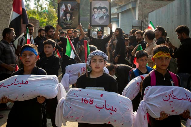 June 28, 2026, Srinagar, Jammu And Kashmir, India: Shiite Muslim children carry shrouded replicas symbolizing the children killed in the Israeli and US strikes on Minab School in Iran during a religious procession on the 12th day of the Islamic month of Muharram, expressing solidarity with the victims, in the outskirts of Srinagar, Indian administered Kashmir. Muharram, the first month of the Islamic calendar, is observed by Shiite Muslims around the world in remembrance of Imam Hussain, the grandson of the Prophet Muhammad, who was killed along with members of his family and companions in the Battle of Karbala in present day Iraq in 680 AD. Srinagar India - ZUMAs197 20260628_aaa_s197_056 Copyright: xFaisalxBashirx