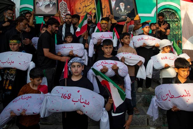 June 28, 2026, Srinagar, Jammu And Kashmir, India: Shiite Muslim children carry shrouded replicas symbolizing the children killed in the Israeli and US strikes on Minab School in Iran during a religious procession on the 12th day of the Islamic month of Muharram, expressing solidarity with the victims, in the outskirts of Srinagar, Indian administered Kashmir. Muharram, the first month of the Islamic calendar, is observed by Shiite Muslims around the world in remembrance of Imam Hussain, the grandson of the Prophet Muhammad, who was killed along with members of his family and companions in the Battle of Karbala in present day Iraq in 680 AD. Srinagar India - ZUMAs197 20260628_aaa_s197_060 Copyright: xFaisalxBashirx
