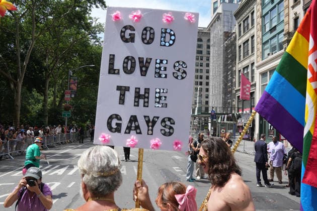 June 28, 2026, New Yok, New York, USA: A participant carries a sign that says God Loves The Gays at the Annual NYC Pride March on June 28, 2026 in New York. NYC s Pride March began as a demonstration honoring the 1969 Stonewall Riots, has evolved into a global symbol of LGBTQIA+ resilience, unity and activism. New Yok USA  - ZUMAb148 20260628_zap_b148_032 Copyright: xBryanxSmithx