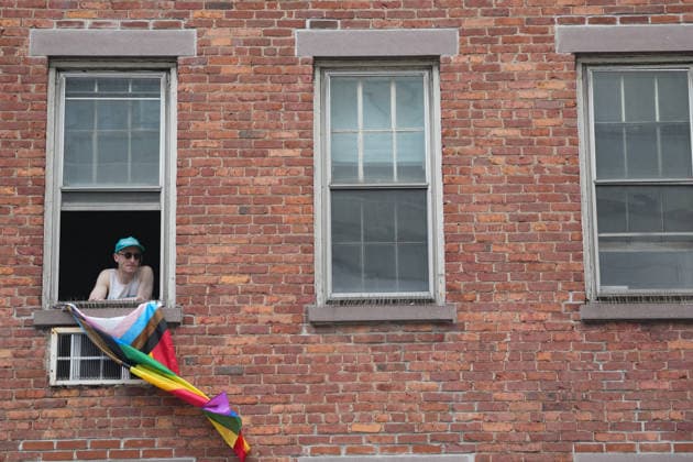June 28, 2026, New Yok, New York, USA: A man looks from his window in the West Village at the Annual NYC Pride March on June 28, 2026 in New York. NYC s Pride March began as a demonstration honoring the 1969 Stonewall Riots, has evolved into a global symbol of LGBTQIA+ resilience, unity and activism. New Yok USA  - ZUMAb148 20260628_zap_b148_050 Copyright: xBryanxSmithx