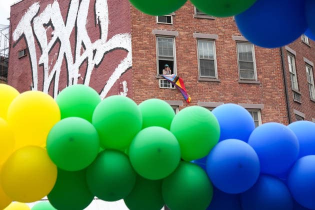 June 28, 2026, New Yok, New York, USA: A man looks from his window in the West Village at rainbow balloons at the Annual NYC Pride March on June 28, 2026 in New York. NYC s Pride March began as a demonstration honoring the 1969 Stonewall Riots, has evolved into a global symbol of LGBTQIA+ resilience, unity and activism. New Yok USA  - ZUMAb148 20260628_zap_b148_062 Copyright: xBryanxSmithx