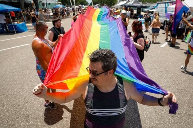 June 28, 2026, St. Petersburg, Florida, USA: Joshua Wallace, 44, of St. Petersburg, helps lead people in carrying a 375-foot-long Pride flag during the St. Pete Pride Grand Central Street Fair at the Grand Central District on Sunday, June 28, 2026, in St. Petersburg. St. Petersburg USA  - ZUMAs70_ 20260628_zan_s70_022 Copyright: xJeffereexWoox
