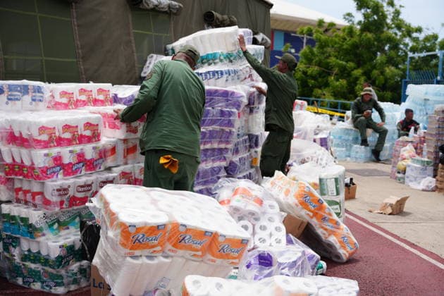 (260629) -- LA GUAIRA, June 29, 2026 -- Venezuela s Bolivarian National Armed Forces members organize humanitarian aid at a sports center in La Guaira, Venezuela, June 28, 2026. Venezuelan National Assembly President Jorge Rodriguez said Sunday that the death toll from two powerful earthquakes that uck Venezuela Wednesday has risen to 1,450. ( Xinhua) (SpotNews) VENEZUELA-LA GUAIRA-EARTHQUAKE-AFTERMATH STR 