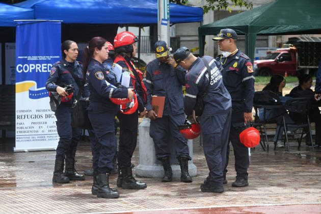 (260629) -- CARACAS, June 29, 2026 -- Firefighters are seen in a square in Caracas, Venezuela, June 28, 2026. Venezuelan National Assembly President Jorge Rodriguez said Sunday that the death toll from two powerful earthquakes that struck Venezuela Wednesday has risen to 1,450. (Photo by Xinhua) (SpotNews) VENEZUELA-CARACAS-EARTHQUAKE-AFTERMATH MarcosxSalgado 