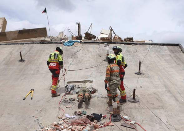 (260629) -- LA GUAIRA, June 29, 2026 -- Rescuers work on a collapsed building in Playa Grande, La Guaira state, Venezuela, June 28, 2026. Venezuelan National Assembly President Jorge Rodriguez said Sunday that the death toll from two powerful earthquakes that uck Venezuela Wednesday has risen to 1,450. ( Xinhua) (SpotNews) VENEZUELA-LA GUAIRA-EARTHQUAKES-DEATH TOLL STR 