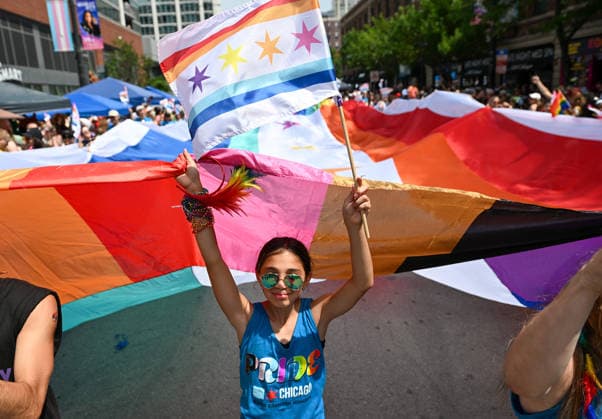 June 28, 2026, Chicago, Illinois, USA: A young girl helps carry a large pride flag through the parade route in Chicago on Sunday June 28th, 2026. Chicago USA - ZUMAd171 20260628_znp_d171_002 Copyright: xSethxDonovanx