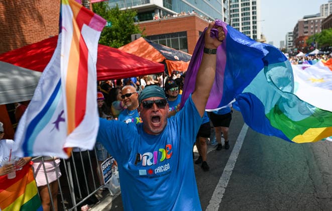 June 28, 2026, Chicago, Illinois, USA: A man shouts in celebration while waving a Chicago pride themed flag on Sunday June 28th, 2026 Chicago USA - ZUMAd171 20260628_znp_d171_003 Copyright: xSethxDonovanx