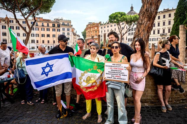 Demonstration for Italy and for Christ against Islam ROME, ITALY - JUNE 29: Demonstrators with the Iranian monarchy tricolour flag with the Lion and Sun and Israeli flag during the demonstration led by Simone Carabella, (not pictured) influencer and anti-urban decay activist, Donatella Zaccagnini Romito (R) influencer and Mario Adinolfi (C) of the People of the Family movement, in defense of Rome and Italy, faith, the family and the future of their children, defended with the crucifix and the Italian flag, opposing what the organizers describe as the threat of Islam on June 29, 2026 in Rome, Italy. Rome Italy Copyright: xStefanoxMontesix