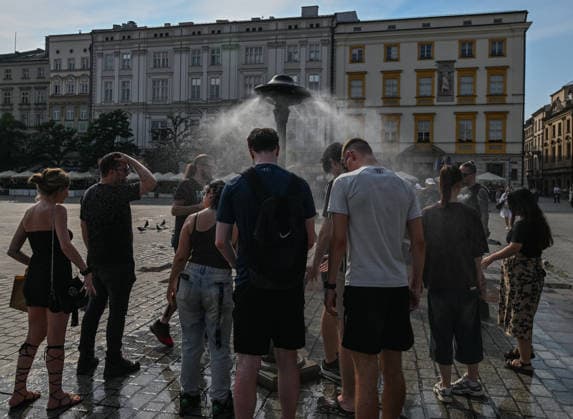Historic Central European Heatwave Grips Krakow As Temperatures Hit 38C KRAKOW, POLAND - JUNE 29: People seek refreshment next to a municipal water spray station installed in the Main Market Square to provide cooling relief in Krakow, Poland, on June 29, 2026. This local snapshot captures conditions amid an unprecedented Central European heatwave, which just yesterday shattered Poland s 105-year-old national record with a blistering 40.5Â°C (104.9Â°F) in Slubice, as active orange alerts remain in place ahead of predicted severe regional storms set to collide with the lingering tropical air mass. Krakow Poland  Copyright: xArturxWidakx originalFilename: widak-historic260629_npAEj.jpg