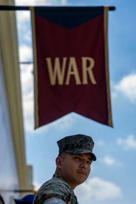 A service member stands outside the Department of War exhibit on the fifth day of the Great American State Fair on the National Mall on Monday, June 29, 2026. The Freedom 250-backed Great American State Fair celebrating the 250th anniversary of the United States runs through July 10th.  WAP20260629401 BONNIExCASH
