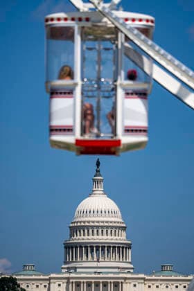 The U.S. Capitol is seen as people ride the ferris wheel during the fifth day of the Great American State Fair on the National Mall on Monday, June 29, 2026. The Freedom 250-backed Great American State Fair celebrating the 250th anniversary of the United States runs through July 10th.  WAP20260629410 BONNIExCASH