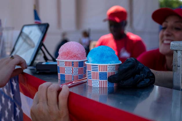 Visitors wait in line for two snow cones during the fifth day of the Great American State Fair on the National Mall on Monday, June 29, 2026. The Freedom 250-backed Great American State Fair celebrating the 250th anniversary of the United States runs through July 10th.  WAP20260629412 BONNIExCASH