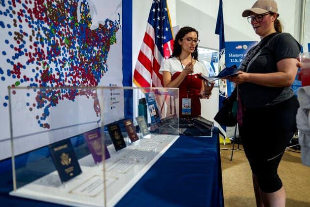 An employee shows Information booklets on the Passport 250 , a limited edition U.S. Passport featuring U.S. President Donald Trump, in the State Department exhibit on the fifth day of the Great American State Fair on the National Mall on Monday, June 29, 2026. The Freedom 250-backed Great American State Fair celebrating the 250th anniversary of the United States runs through July 10th.  WAP20260629429 BONNIExCASH
