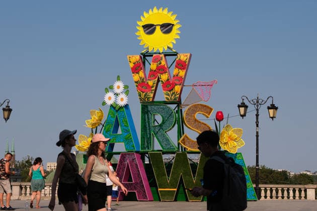 June 29, 2026, Warsaw, Masovian Voivodeship, Poland: People pass in front of a large Warsaw sign in summertime decorations during severe heat in Warsaw, Poland. This was the second day in a row that temperatures in the Polish capital climbed over 35Ã‚Â°C, as a scorching heat dome moves eastwards across Europe, bringing with it record-breaking high temperatures. Warsaw Poland - ZUMAk204 20260629_zip_k204_036 Copyright: xRomanxKozielx