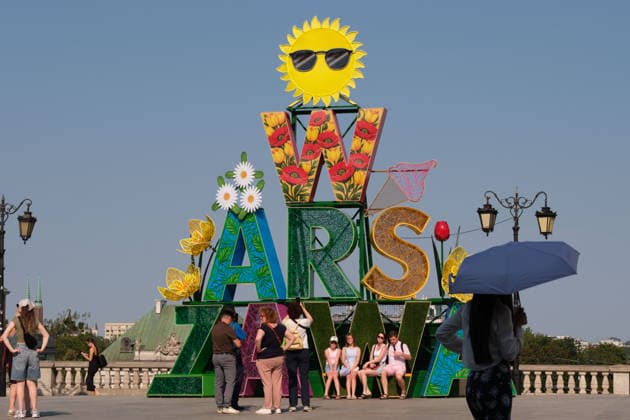 June 29, 2026, Warsaw, Masovian Voivodeship, Poland: People pass and pose for photos in front of a large Warsaw sign in summertime decorations during severe heat in Warsaw, Poland. This was the second day in a row that temperatures in the Polish capital climbed over 35Ã‚Â°C, as a scorching heat dome moves eastwards across Europe, bringing with it record-breaking high temperatures. Warsaw Poland - ZUMAk204 20260629_zip_k204_040 Copyright: xRomanxKozielx