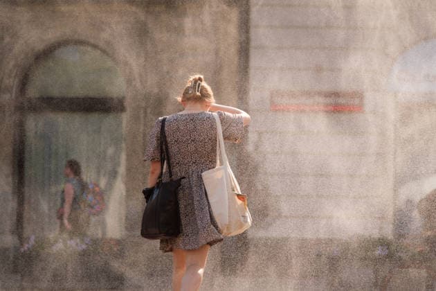 June 29, 2026, Warsaw, Masovian Voivodeship, Poland: A girl shields herself from the blistering sun as she walks under a mist sprinkler during severe heat in Warsaw, Poland. This was the second day in a row that temperatures in the Polish capital climbed over 35Ã‚Â°C, as a scorching heat dome moves eastwards across Europe, bringing with it record-breaking high temperatures. Warsaw Poland - ZUMAk204 20260629_zip_k204_046 Copyright: xRomanxKozielx