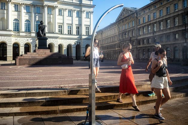 June 27, 2026, Warsaw, Mazovia, Poland: Ladies enjoy the relief of a cooling misting station. On the afternoon of the 28th of June, Varsovians cool and hydrate themselves around the city during a record-breaking heatwave. Due to the extreme heat, the authorities provided misting sprays and water tanks around the city. During the weekend, Warsaw experienced temperatures approaching 38Â°C as the unprecedented European heatwave swept across Poland, roughly 15Â°C above the late-June average. Tropical nights, nationwide heat alerts, and temperatures up to 40.5Â°C elsewhere in the country made this one of the most extreme heat events in modern Polish history. Warsaw Poland - ZUMAs197 20260627_aaa_s197_332 Copyright: xNeilxMiltonx