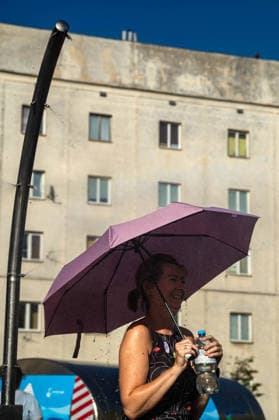 June 27, 2026, Warsaw, Mazovia, Poland: Under a parasol, a lady enjoys the relief of a cooling misting station. On the afternoon of the 28th of June, Varsovians cool and hydrate themselves around the city during a record-breaking heatwave. Due to the extreme heat, the authorities provided misting sprays and water tanks around the city. During the weekend, Warsaw experienced temperatures approaching 38Â°C as the unprecedented European heatwave swept across Poland, roughly 15Â°C above the late-June average. Tropical nights, nationwide heat alerts, and temperatures up to 40.5Â°C elsewhere in the country made this one of the most extreme heat events in modern Polish history. Warsaw Poland - ZUMAs197 20260627_aaa_s197_333 Copyright: xNeilxMiltonx